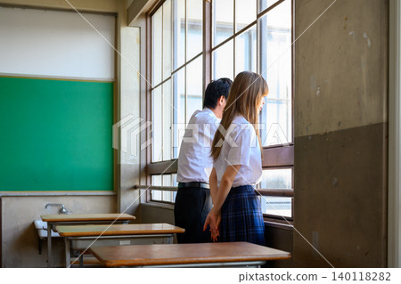 Students looking out the window in the classroom Students looking out the window in the classroom 140118282