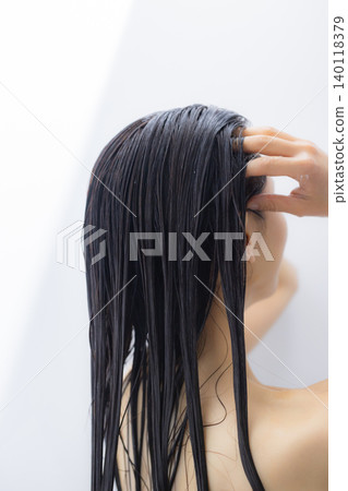 A woman shampooing A woman shampooing 140118379