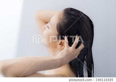 A woman shampooing A woman shampooing 140118385