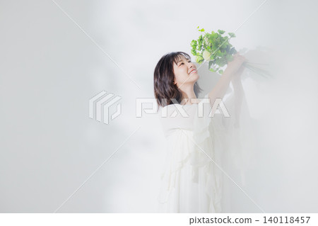 Young woman with a bouquet Young woman with a bouquet 140118457