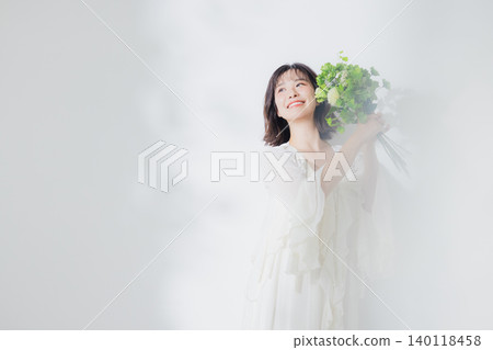 Young woman with a bouquet Young woman with a bouquet 140118458