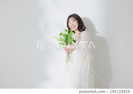 Young woman with a bouquet Young woman with a bouquet 140118459