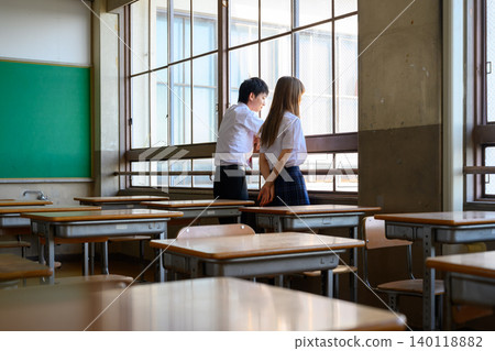 Students looking out the window in the classroom Students looking out the window in the classroom 140118882
