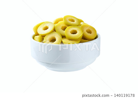 Cut green olive rings in a white ceramic bowl isolated on a white background. Cut green olive rings in a white ceramic bowl isolated on a white background. 140119178