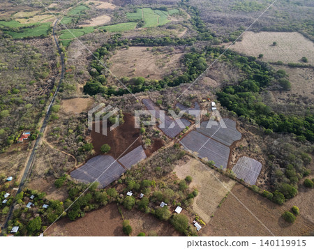 Solar panels and farmland in a rural area during daytime Solar panels and farmland in a rural area during daytime 140119915