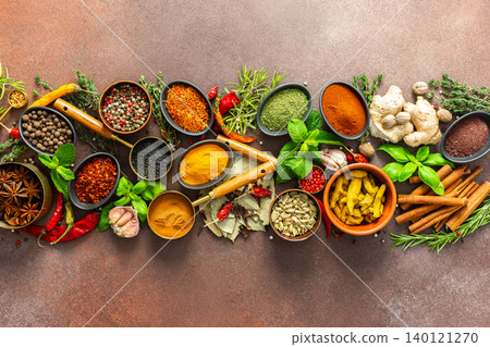 A stunning spread of fresh spices and herbs, meticulously arranged on a deep brown backdrop, capturing their vibrant colors and tantalizing aromas A stunning spread of fresh spices and herbs, meticulously arranged on a deep brown backdrop, capturing their vibrant colors and tantalizing aromas 140121270