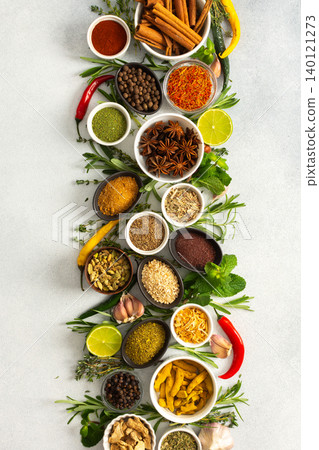 A beautiful display of cooking spices and dried herbs on a gray background, offering a palette of natural hues ideal for culinary inspiration A beautiful display of cooking spices and dried herbs on a gray background, offering a palette of natural hues ideal for culinary inspiration 140121273