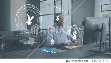 Working Asian man at office wearing blue shirt, headset, using monitor, tablet with AR money icons Working Asian man at office wearing blue shirt, headset, using monitor, tablet with AR money icons 140121457