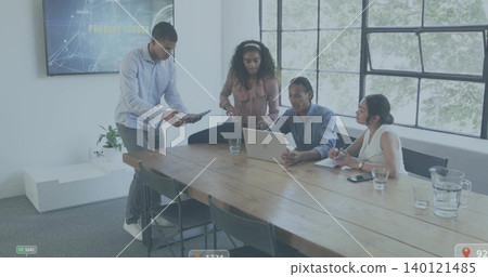 Discussing team in business casual reviewing laptop and tablet at modern office meeting room Discussing team in business casual reviewing laptop and tablet at modern office meeting room 140121485