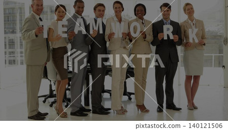 Holding office team wearing suits standing by glass walls near table, displaying letters TEAMWORK Holding office team wearing suits standing by glass walls near table, displaying letters TEAMWORK 140121506