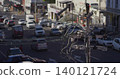 Showing wooden utility pole carrying tangled cables at downtown crossroads with traffic, copy space 140121724
