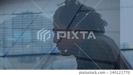 Leaning profile man in sweater studying monitor at office desk, with glass wall and grid overlay Leaning profile man in sweater studying monitor at office desk, with glass wall and grid overlay 140121770