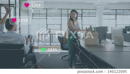 Holding cardboard box and metal kettle, woman wearing gray tank and green pants in open-plan office Holding cardboard box and metal kettle, woman wearing gray tank and green pants in open-plan office 140122095