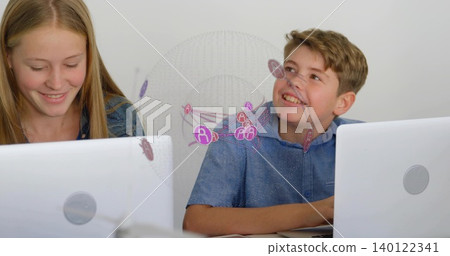 Pair wearing denim jacket, blue shirt typing on white laptops in class, showing pink network visual Pair wearing denim jacket, blue shirt typing on white laptops in class, showing pink network visual 140122341