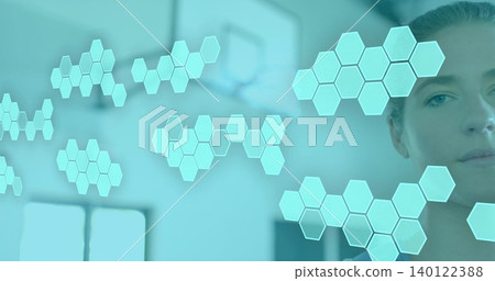 Studying woman on right in light top viewing floating hexagon holo tiles in clinic, copy space Studying woman on right in light top viewing floating hexagon holo tiles in clinic, copy space 140122388