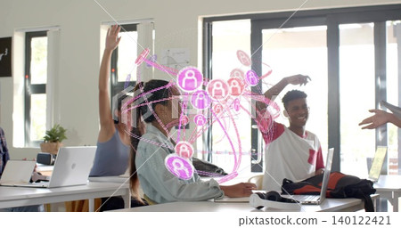 Smiling students sitting at campus study space, raising hands, using laptops and pink AR overlay Smiling students sitting at campus study space, raising hands, using laptops and pink AR overlay 140122421