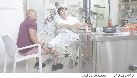 Inspecting clinician in white scrubs adjusting prosthetic leg on steel bench, tools visible Inspecting clinician in white scrubs adjusting prosthetic leg on steel bench, tools visible 140122440