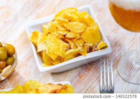Image of chips, olives, beer Image of chips, olives, beer 140122578