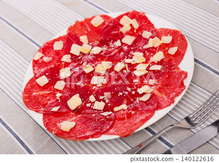 Carpaccio - appetizer made with thin slices of raw meat and parmesan cheese 140122616