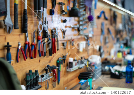 Empty workshop for bike repair with table with different tools Empty workshop for bike repair with table with different tools 140122657