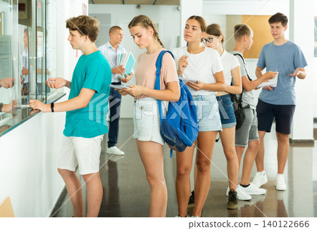Teenagers standing in line 140122666