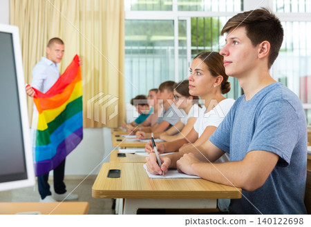 Student making notes during lecture about LGBT community Student making notes during lecture about LGBT community 140122698