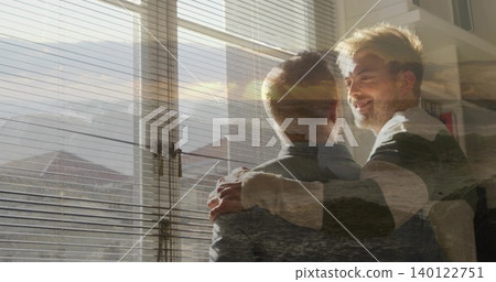 Standing men embracing, wearing shirt, jacket by window with blinds, shelf, sea overlay, copy space Standing men embracing, wearing shirt, jacket by window with blinds, shelf, sea overlay, copy space 140122751