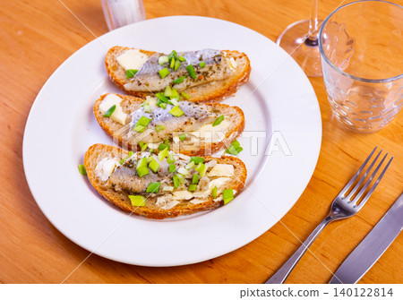 Closeup of delicious sandwich with herring, onions, and butter Closeup of delicious sandwich with herring, onions, and butter 140122814