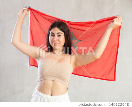 Happy young woman with flag of Monaco against unicoloured background Happy young woman with flag of Monaco against unicoloured background 140122948