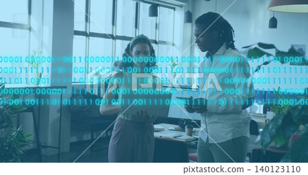 Woman in sleeveless top and man in button-down discussing tablet in office with binary overlay Woman in sleeveless top and man in button-down discussing tablet in office with binary overlay 140123110