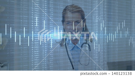 Standing doctor facing in clinic wearing lab coat, collared shirt and stethoscope with data overlay Standing doctor facing in clinic wearing lab coat, collared shirt and stethoscope with data overlay 140123138