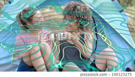 Passing two friends in shorts sharing camping mug inside blue-yellow dome tent, teal overlay Passing two friends in shorts sharing camping mug inside blue-yellow dome tent, teal overlay 140123275
