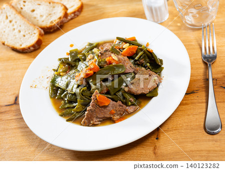 Beef stew served with green beans Beef stew served with green beans 140123282