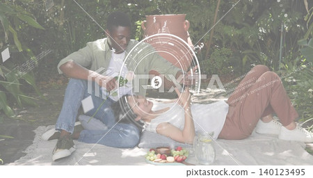 Relaxing couple sitting on picnic blanket in shaded garden, in casual clothes, pitcher and HUD seen Relaxing couple sitting on picnic blanket in shaded garden, in casual clothes, pitcher and HUD seen 140123495
