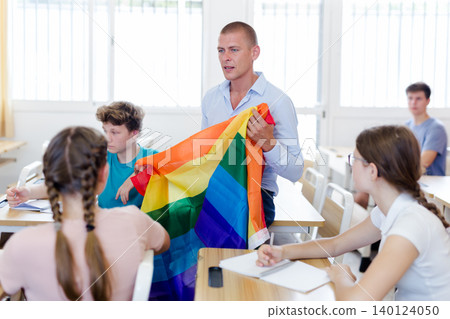 Teacher discussing with teenage students about LGBT in classroom 140124050