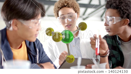 Pointing white lab coat student explaining AR molecular model at lab bench, holding test tube Pointing white lab coat student explaining AR molecular model at lab bench, holding test tube 140124130