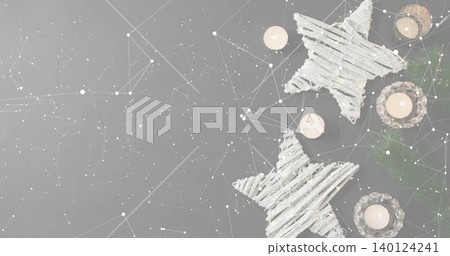 Glowing twig stars and lit tea lights creating cozy holiday scene on gray tabletop, copy space Glowing twig stars and lit tea lights creating cozy holiday scene on gray tabletop, copy space 140124241