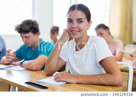 Pupils sitting in class and listening 140124316