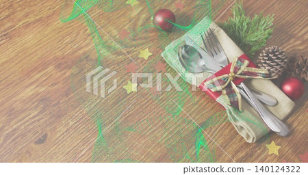 Displaying steel cutlery wrapped in beige napkin with ribbon and pinecone on wood table, copy space Displaying steel cutlery wrapped in beige napkin with ribbon and pinecone on wood table, copy space 140124322