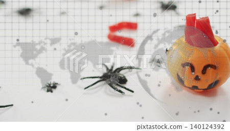 Showing pumpkin with red wrap sitting on grid backdrop, with two spiders, map overlay, copy space Showing pumpkin with red wrap sitting on grid backdrop, with two spiders, map overlay, copy space 140124392