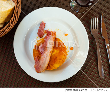 There is portion of casserole made from boiled potatoes and cabbage on plate. There is portion of casserole made from boiled potatoes and cabbage on plate. 140124427