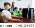 Portrait of guy working at computer in computer class at school 140124453
