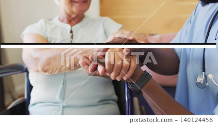 Holding senior patient hands while caregiver supporting in blue scrubs care room watch gold ring Holding senior patient hands while caregiver supporting in blue scrubs care room watch gold ring 140124456
