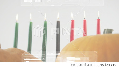 Showing seven lit taper candles green-black-red on table with two pumpkins and faint HUD overlays Showing seven lit taper candles green-black-red on table with two pumpkins and faint HUD overlays 140124540
