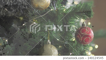 Showing trimmed fir branch glowing with lights at home, with red bauble, gold orb and halftone Showing trimmed fir branch glowing with lights at home, with red bauble, gold orb and halftone 140124545
