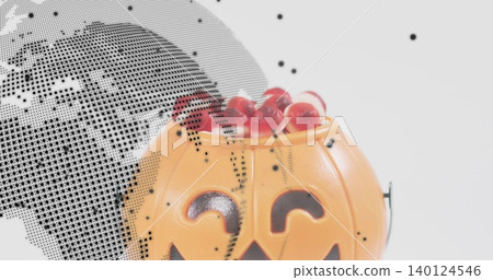 Showing pumpkin bucket holding red candies on white backdrop with halftone overlay, copy space Showing pumpkin bucket holding red candies on white backdrop with halftone overlay, copy space 140124546