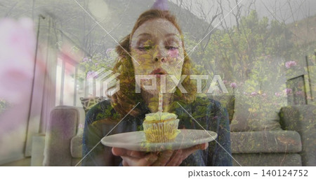 Blowing woman in dark clothes holding white plate with frosted cupcake in lounge, floral overlay Blowing woman in dark clothes holding white plate with frosted cupcake in lounge, floral overlay 140124752
