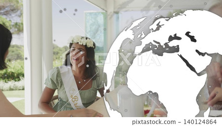Sitting bride-to-be wearing floral crown, sash reading Bride and light green dress at garden table Sitting bride-to-be wearing floral crown, sash reading Bride and light green dress at garden table 140124864