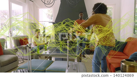 Gesturing man in mustard sweater talking with group by glass table, suitcase and tablet, copy space Gesturing man in mustard sweater talking with group by glass table, suitcase and tablet, copy space 140124869