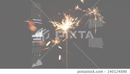 Emitting single lit sparkler sending sparks and trails in dim studio, metal stem and charts, bokeh Emitting single lit sparkler sending sparks and trails in dim studio, metal stem and charts, bokeh 140124890